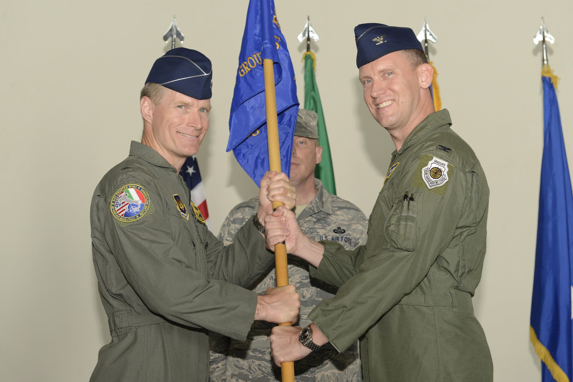 Col. Richard Nelson took command of the 31st Operations Group from Col. Craig Hollis during a change of command ceremony, July 10, 2017, at Aviano Air Base, Italy. Brig. Gen. Lance Landrum, 31st Fighter Wing commander, presided over the event. (U.S. Air Force photo by Tech. Sgt. Andrew Satran)