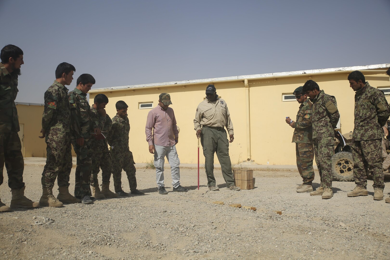 A counter improvised explosive device instructor teaches proper route clearance procedures using a terrain model to Afghan National Army soldiers with 215th Corps at Camp Shorabak, Afghanistan, July 13, 2017. Several U.S. Marine advisors with Task Force Southwest and instructors began a route clearance course July 8, which is designed to help improve the mobility of ANA forces in Helmand Province. (U.S. Marine Corps photo by Sgt. Lucas Hopkins)