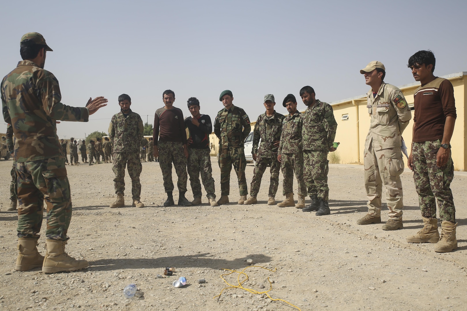 An Afghan National Army soldier with 215th Corps instructs his fellow soldiers on indicators of improvised explosive devices at Camp Shorabak, Afghanistan, July 13, 2017. Approximately 70 engineer soldiers with various units from the 215th Corps began a route clearance course July 8 with assistance from U.S. Marine advisors assigned to Task Force Southwest. The eight-week course is designed to bolster the soldiers’ route clearance capabilities to help promote maneuverability amongst infantry kandaks and supplies in Helmand Province. (U.S. Marine Corps photo by Sgt. Lucas Hopkins)