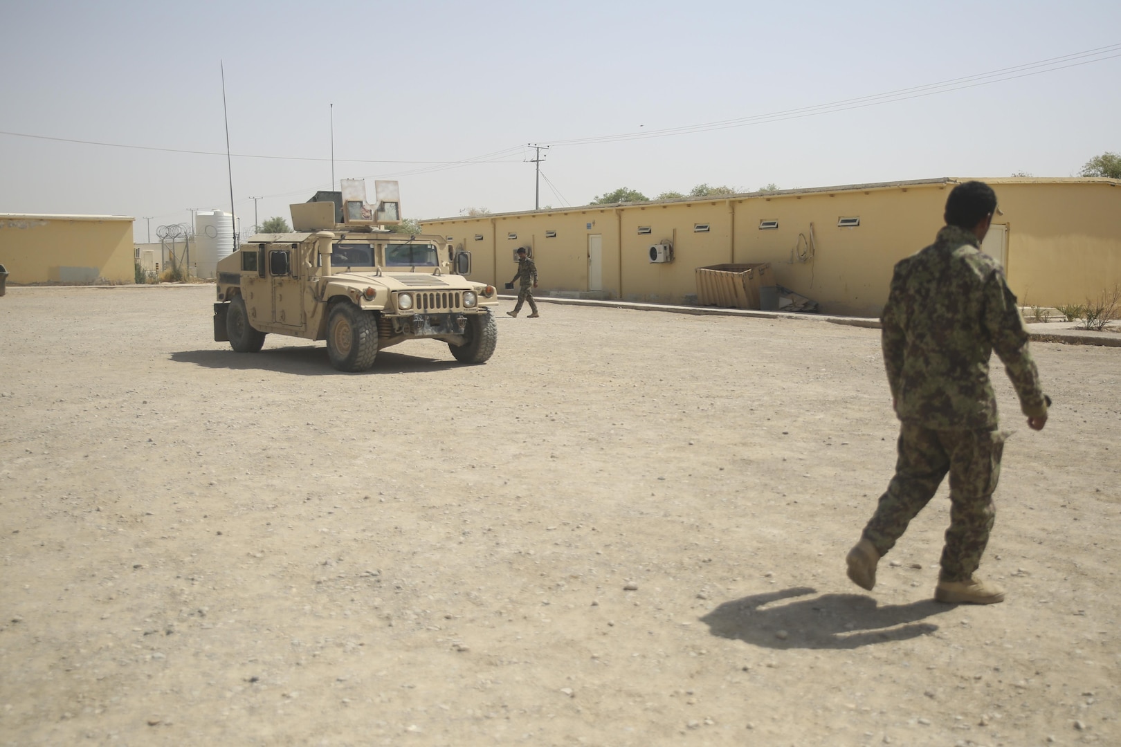 Afghan National Army soldiers with 215th Corps check for notional improvised explosive devices around a Humvee at Camp Shorabak, Afghanistan, July 13, 2017. Several U.S. Marine counter IED advisors recently began a route clearance course with approximately 70 Afghan soldiers, which is designed to enhance the maneuverability of 215th Corps units, supplies and civilians throughout Helmand Province. (U.S. Marine Corps photo by Sgt. Lucas Hopkins)