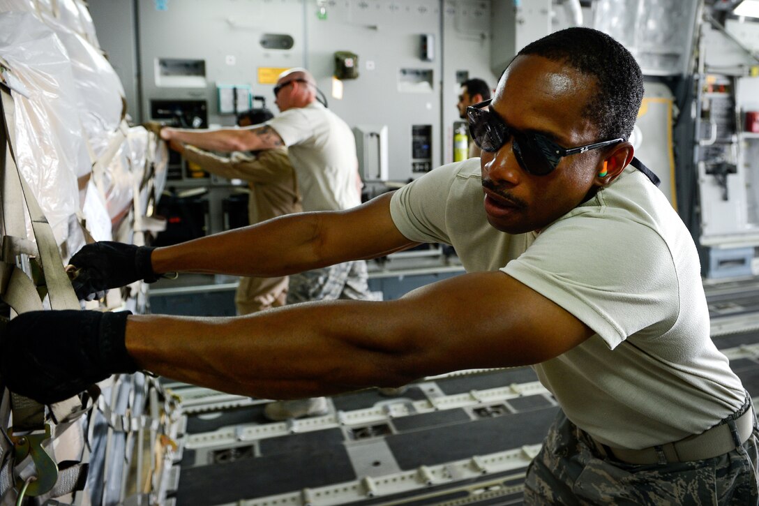 U.S. airmen load equipment and supplies into a Qatari air force C-17 Globemaster III at Al Udeid Air Base, Qatar, July 2, 2017, for a mission supporting Operation Inherent Resolve. Air Force photo by Staff Sgt. Michael Battles