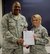 Commander of the 932nd Airlift Wing, Col. Esteban Ramirez, presents a letter of appreciation to Tech. Sgt. Sarah Hughes, 932nd Security Forces Squadron, for taking the lead behind the scenes work in preparation for the recent 932nd Combat Dining In at Scott Air Force Base, Illinois.  She helped with funds, equipment, securing the venue and managing the volunteers.  In addition to training security Airmen, the 932nd AW is an Air Force Reserve flying unit located in Illinois and the only reserve unit utilizing the C-40 aircraft.  (U.S. Air Force photo by Tech. Sgt. Christopher Parr)