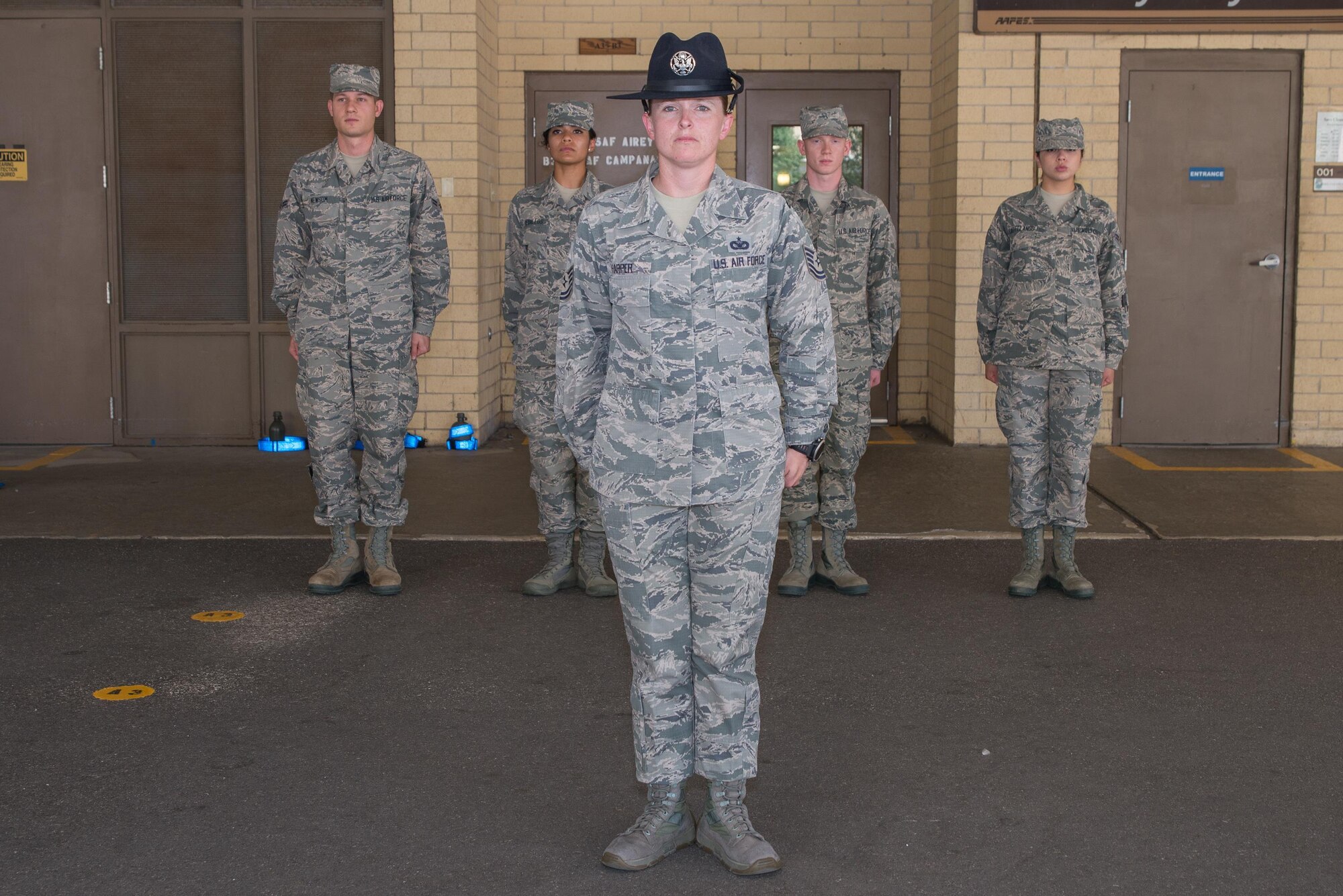 Tech. Sgt. Megan Harper stands at attention with Airman under the overhang at the 326th Training Squadron at Joint Base San Antonio-Lackland, Texas. June 28, 2017. Harper has been selected as the Military Times’ 2017 Airman of the Year for her exceptional service over the course of a 15-year Air Force career. 