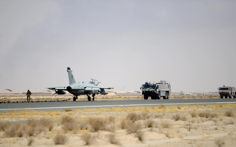 U.S. Air Force fire fighters assigned to the 407th Expeditionary Civil Engineer Squadron, respond to an aircraft distress call during an Aircraft Arresting System engagement with an Italian Air Force AMX A-11 Ghibli aircraft in Southwest Asia on July 3, 2017. The 407th ECES fire department operate as first responders to all U.S. and coalition aircraft in the area of responsibility. (U.S. Air Force photo by Tech. Sgt. Andy M. Kin)