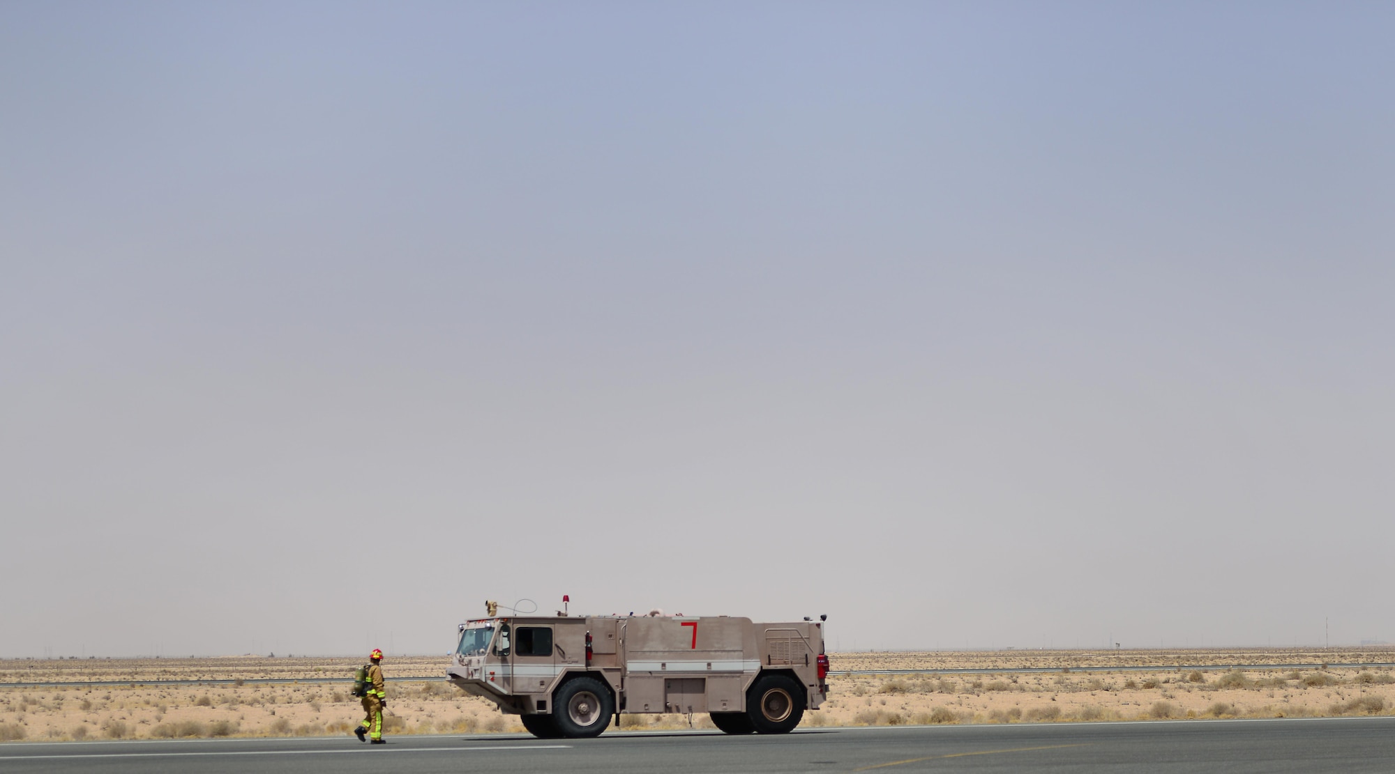 U.S. Air Force fire fighters assigned to the 407th Expeditionary Civil Engineer Squadron, walk back to their trucks after a simulated in-flight emergency response to an Italian Air Force AMX A-11 Ghibli aircraft during an Aircraft Arrested System engagement in Southwest Asia on July 3, 2017. The 407th ECES fire department operate as first responders to all U.S. and coalition aircraft in the area of responsibility. (U.S. Air Force photo by Tech. Sgt. Andy M. Kin)