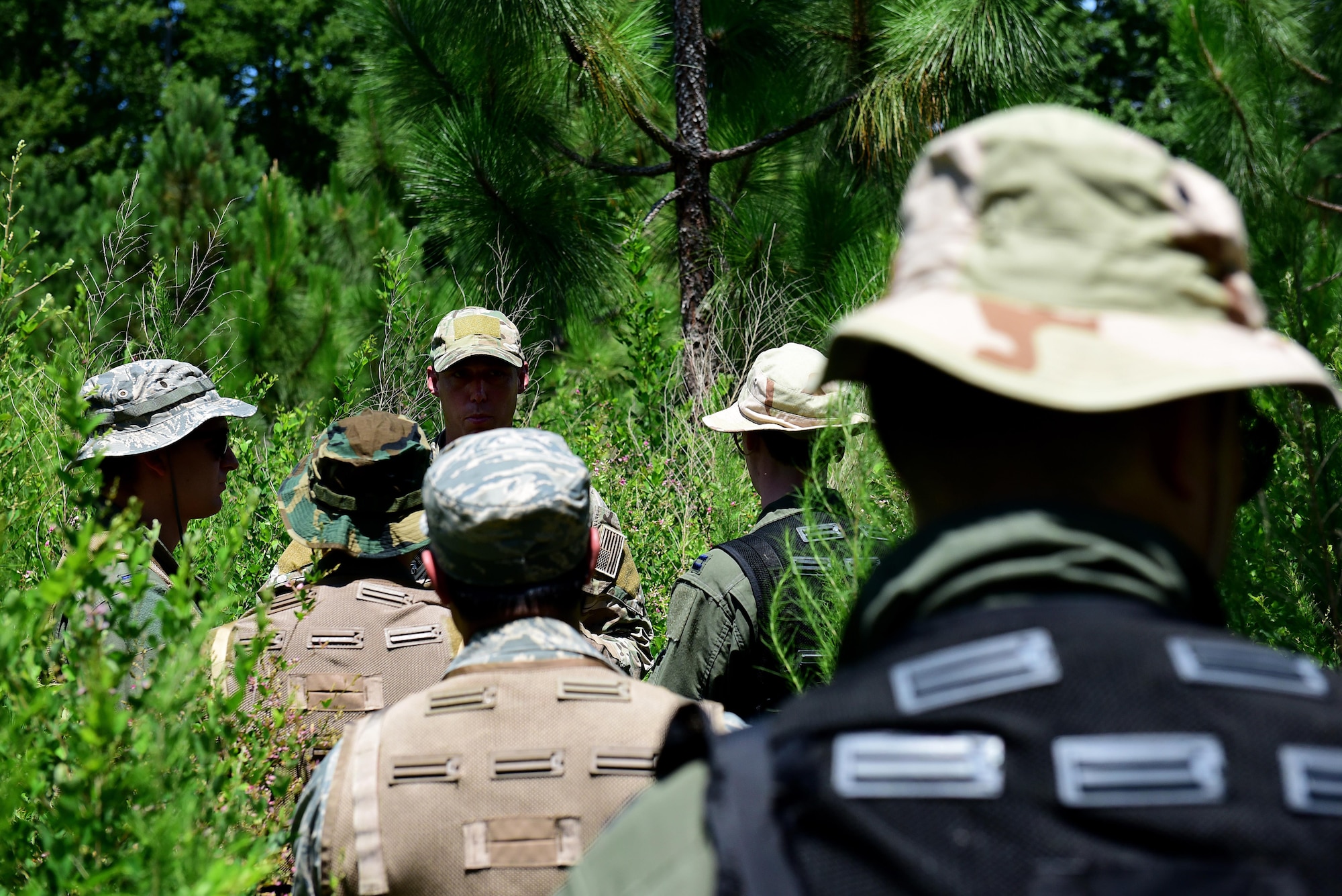 Staff Sgt. Joshua Krape, 4th Operations Support Squadron survival, evasion, resistance and escape specialist, teaches pilots and weapons systems officers from Seymour Johnson Air Force Base, North Carolina, how to survive after ejecting from an aircraft during a combat survival training course, June 27, 2017, at Howell Woods, Four Oaks, North Carolina. The CST course, which can last for over eight hours, consists of survival techniques such as how to create shelter, start a fire, and navigate with minimal equipment. (U.S. Air Force photo by Airman 1st Class Kenneth Boyton)