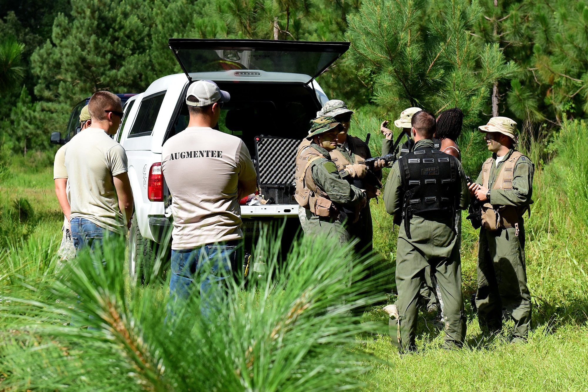 Survival, evasion, resistance and escape augmentees, pilots, and weapons systems officers from Seymour Johnson Air Force Base, North Carolina, prepare to simulate a downed aircraft incident during a combat survival training course, June 27, 2017, at Howell Woods, Four Oaks, North Carolina. SERE augmentees play an integral part during the CST by readying and preparing the equipment, role-playing as enemy and friendly forces, and by helping pilots and WSO’s get the most out of the training. (U.S. Air Force photo by Airman 1st Class Kenneth Boyton)