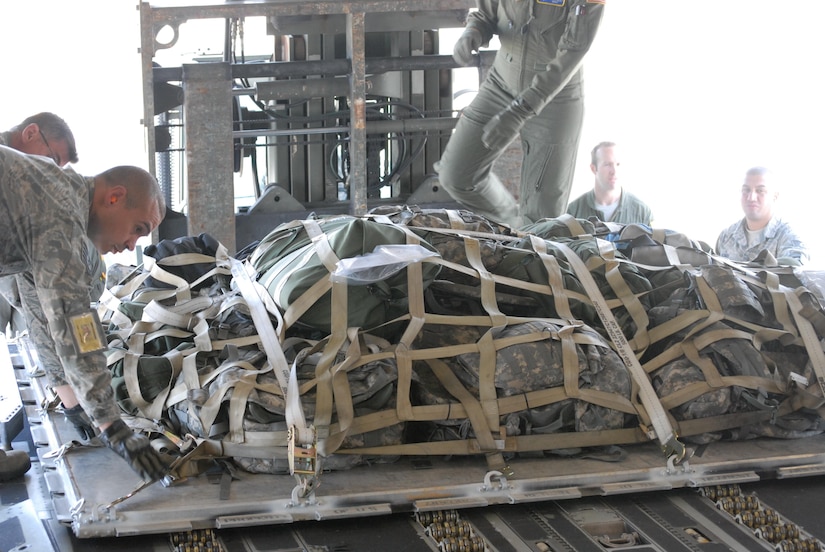 Gear from the 77th Sustainment Brigade's 851st Trailer Transfer Point Detachment work with the Air Force to secure their gear in C-17 during an exercise to test deployment readiness.