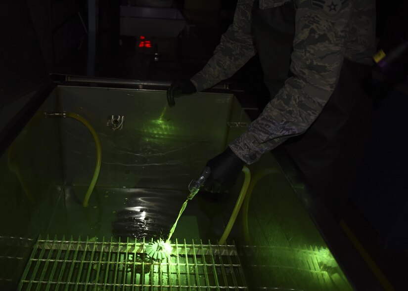 Senior Airman Brett Gyurnek , 437th Maintenance Squadron Non-Destructive Inspection technician, covers a core reverser gear with fluorescent penetrant during a deficiency inspection at Joint base Charleston, S.C. July 10, 2017. Fluorescent penetrant testing is a reliable way to illuminate fractures on the surface of damaged aircraft parts. It is done by submerging the part in a fluorescent liquid and allowing the dye to penetrate into any cracks. The liquid is then rinsed off and placed in a developing agent which makes the fluorescent liquid illuminate brighter under an ultraviolet light. The part is then placed under an ultraviolet light and, if cracks are present, they will light up and make the deficiency more visible.