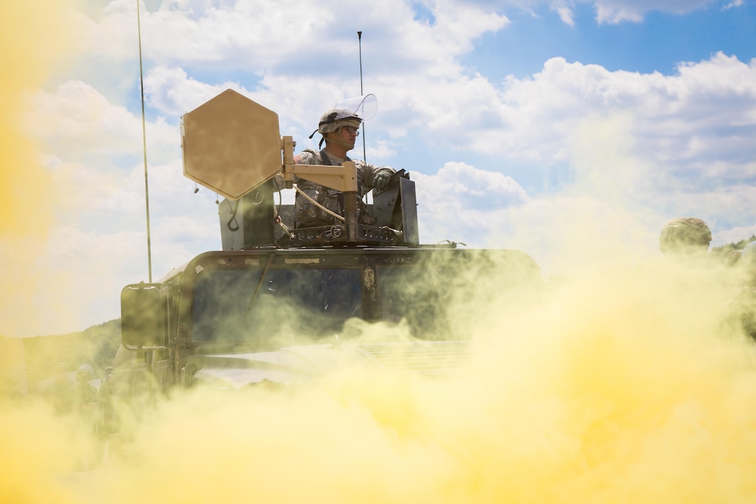 A soldier utilizes a long-range acoustic device while participating in a  crowd riot control scenario during a Kosovo Force mission rehearsal exercise at the Joint Multinational Readiness Center in Hohenfels, Germany, July 5, 2017. Army photo by Spc. Randy Wren