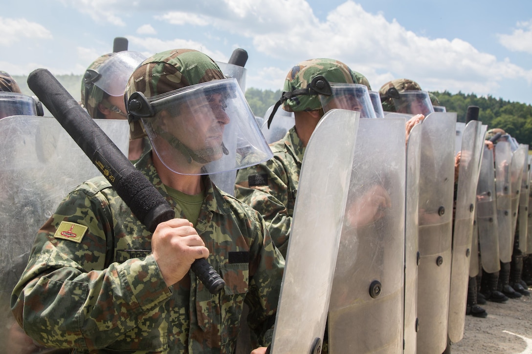 Albanian soldiers prepare to engage a hostile crowd while conducting a simulated crowd riot control scenario during a Kosovo Force mission rehearsal exercise at the Joint Multinational Readiness Center in Hohenfels, Germany, July 5, 2017. Army photo by Spc. Randy Wren
