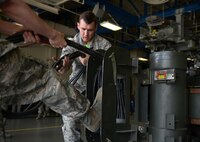 Senior Airman Luke Ryan, 705th Munitions Squadron special purpose vehicle operator and Airman 1st Class Jacob Lowe, 705th MUNS team member roll up a common strategic rotery launcher electrical cord Challenge at Minot Air Force Base, N.D., June 30, 2017. The Airmen were part of a team that participated in a mate-and-tow maneuver during Global Strike Challenge 2017. (U.S. Air Force photo by Staff Sgt. Chad Trujillo)