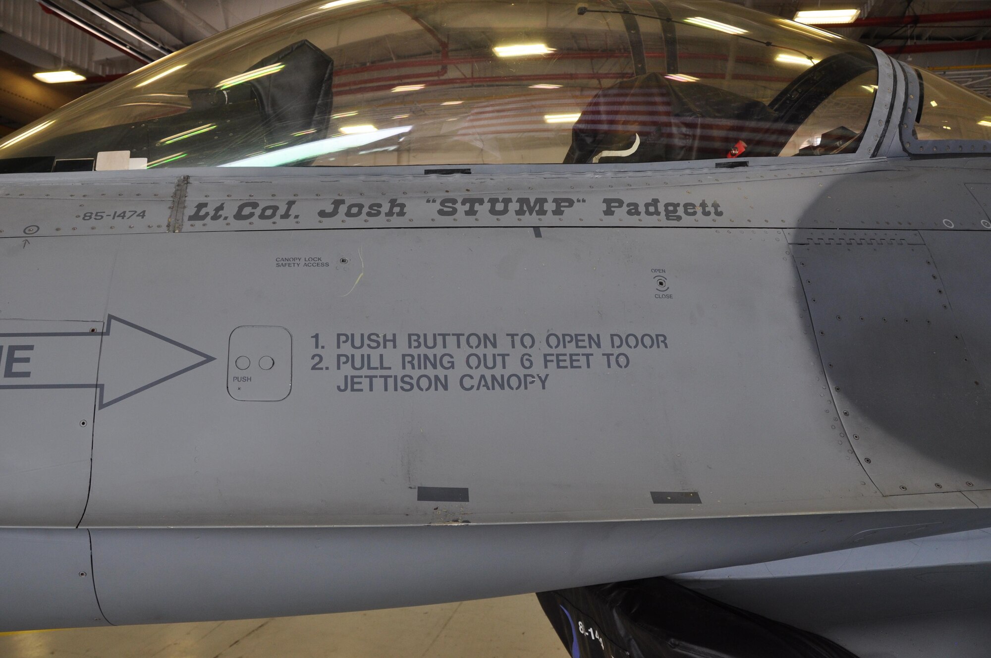 NAVAL AIR STATION FORT WORTH JOINT RESERVE BASE, Texas - A 301st Aircraft Maintenance Squadron crew chief unveils the 457th Fighter Squadron commander's name on the flagship F-16 during a change of command ceremony here July. Flagships are dedicated aircraft with the squadron commander and dedicated crew chief's names painted new the cockpit. (U.S. Air Force photo by Tech. Sgt. Charles Taylor)