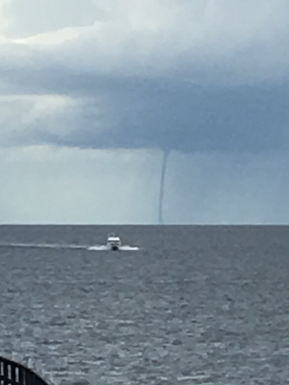 Boat heads for safe harbor with waterspout on Lake Okeechobee visible from Port Mayaca.