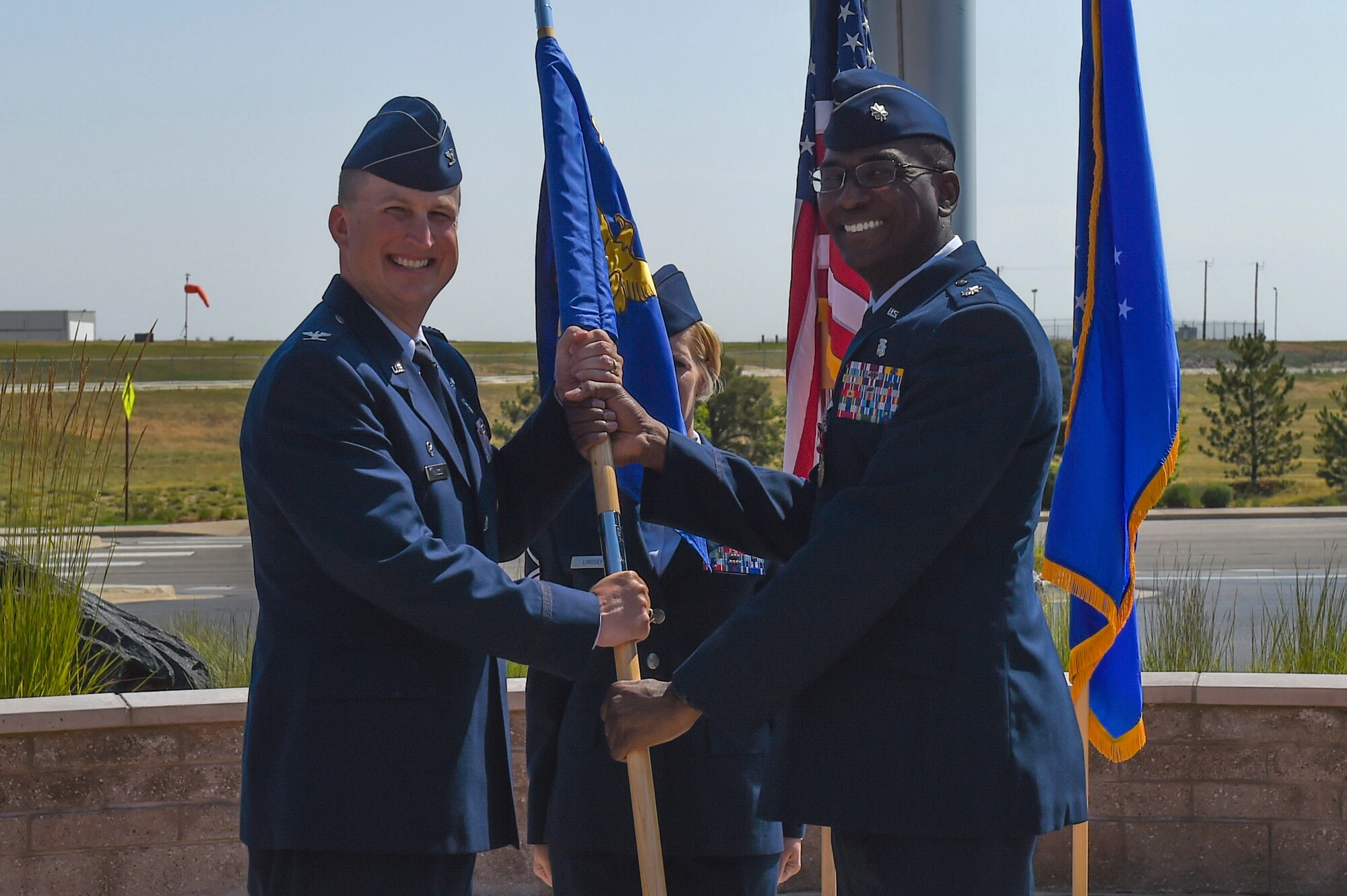 Lt. Col. Alvin Scott, Jr., 460th Medical Support Squadron outgoing commander, relinquishes the guidon to Col. Matthew Hanson, 460th Medical Group commander, July 7, 2017, on Buckley Air Force Base, Colo. The 460th MDSS provides all administration, information systems and communication, resource management, logistical and facility management, and readiness for the Buckley community. (U.S. Air Force photo by Senior Airman Luke Nowakowski/Released)