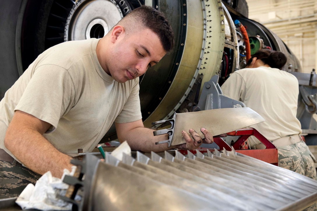 Air Force Senior Airman Steven Valencia cleans and inspects fan blades on a TF-34 engine at Kadena Air Base, Japan, July 6, 2017. Valencia is an aerospace propulsion journeyman assigned to the 18th Component Maintenance Squadron. Air Force photo by Senior Airman John Linzmeier