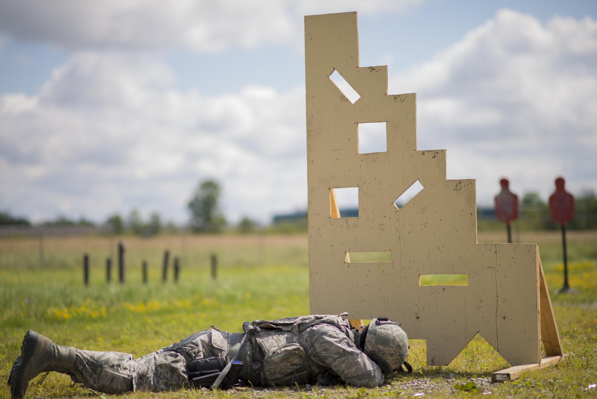 Senior Airman Nelson Andrade, 914th Security Forces, lies in prone position as he aims his M4 rifle at a target during Security Forces annual training, July 11, 2017, Niagara Falls Air Reserve Station, N.Y. The training focuses on communication and execution of maneuvers, ensuring SFS Airmen are well versed in smoothly and efficiently carrying out procedures in real-world situations. (U.S. Air Force photo by Tech. Sgt. Stephanie Sawyer) 