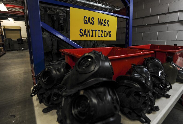 Gas masks are set in place before being put into a sanitizing solution at Hurlburt Field, Fla., July 10, 2017. Material management specialists with the 1st Special Operations Logistics Readiness Squadron use a chlorine solution to wash the gas masks, which are then rinsed in water and set to dry overnight. Once dry, a Joint Service Mask Leakage Tester is used to check for leaks or blocks in the masks. (U.S. Air Force photo by Airman 1st Class Isaac O. Guest IV)