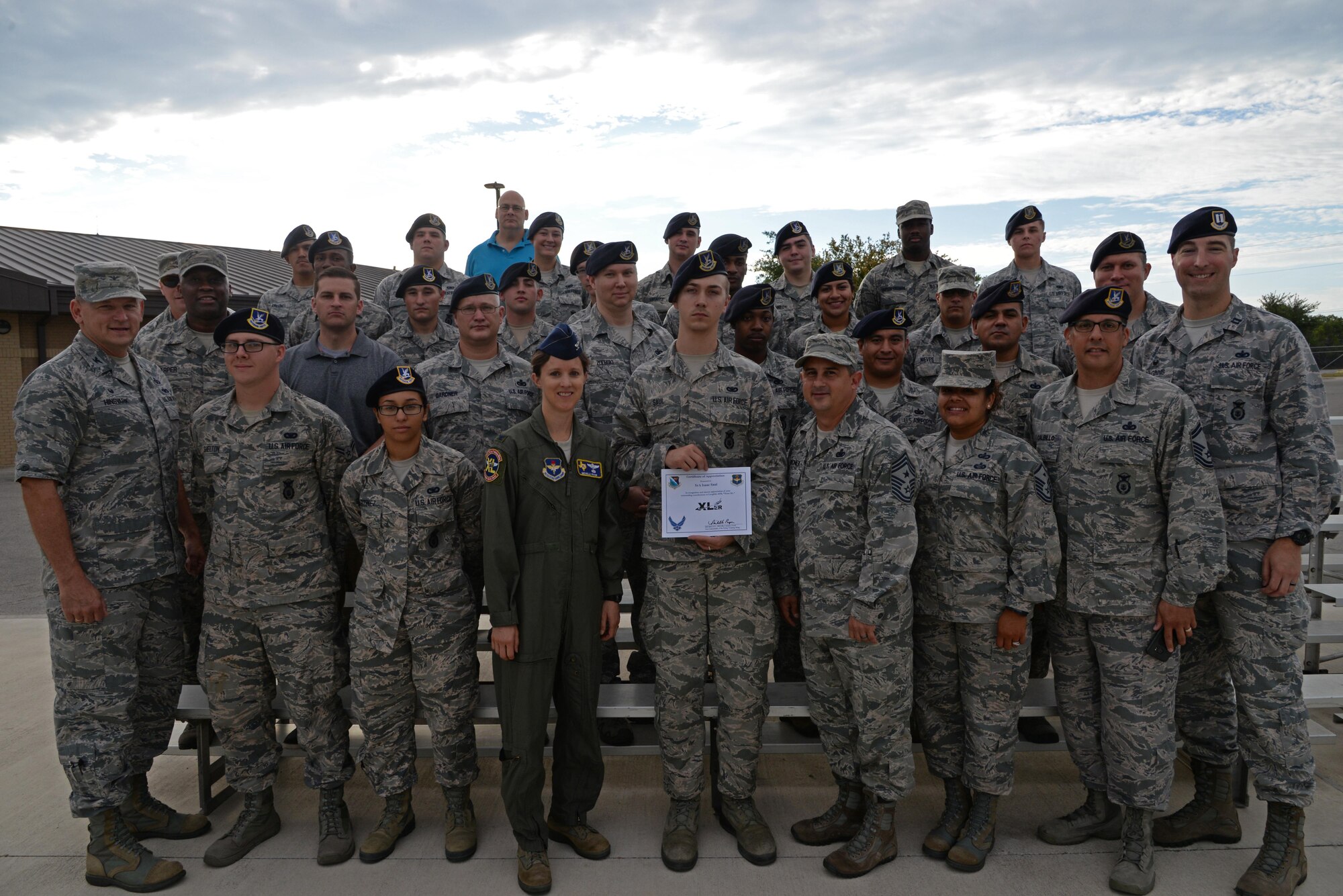 “XLer of the week” winner, U.S. Air Force SrA Isaac L. W. Saul accepts his award with members of the 47th Security Forces Squadron, along with Col. Michelle Pryor, 47th Flying Training Wing vice commander, and Chief Master Sgt. George Richey, 47th FTW command chief, at Laughlin Air Force Base, Tx., July 12, 2017. The “XLer” award, presented by wing leadership, is given to those who consistently make outstanding contributions to their unit, and Laughlin mission.