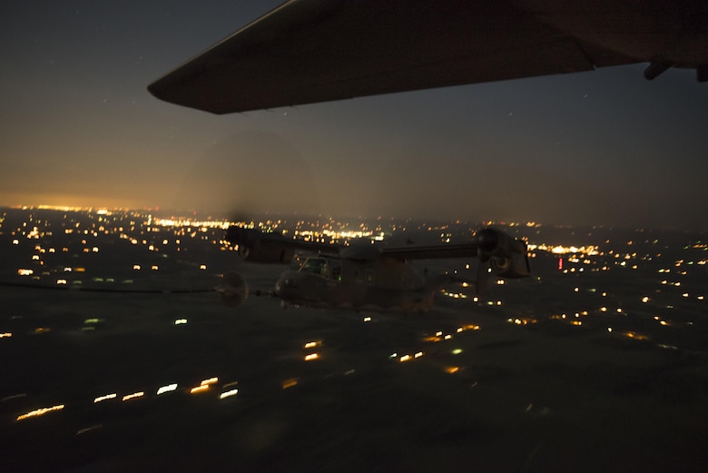 An 8th Special Operations Squadron CV-22 Osprey tiltrotor aircraft receives fuel from a 15th SOS MC-130H Combat Talon II during a total force exercise night-time aerial refueling mission over Louisville, KY., July 9, 2017. Units from the 1st Special Operations Wing conduct quarterly exercises with other units and services to increase consistency in tactics and procedures, ensuring their global readiness. (U.S. Air Force photo by Tech. Sgt. Jeffrey Curtin)