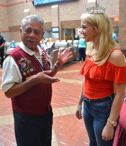 Brooke Army Medical Center volunteer Pedro Rivera chats with Miss America Savvy Shields in the BAMC Medical Mall during her visit July 11. Shields signed autographs, took photos and talked with wounded service members, staff and family members. 