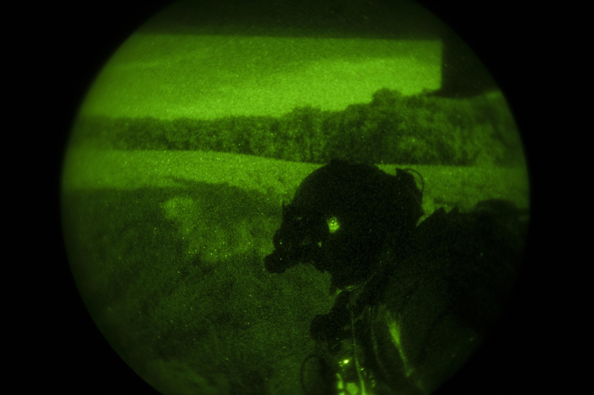 A special missions aviator with the 8th Special Operations Squadron scans for friendly forces during a total force exercise 17-3 infiltration and exfiltration mission at Camp Atterbury, Ind., July 9, 2017. During the exercise, aircrew with the 8th SOS conducted infiltration and exfiltration of special operations forces and air-to-air refueling missions with a 15th SOS MC-130H Combat Talon II. (U.S. Air Force photo by Airman 1st Class Joseph Pick)