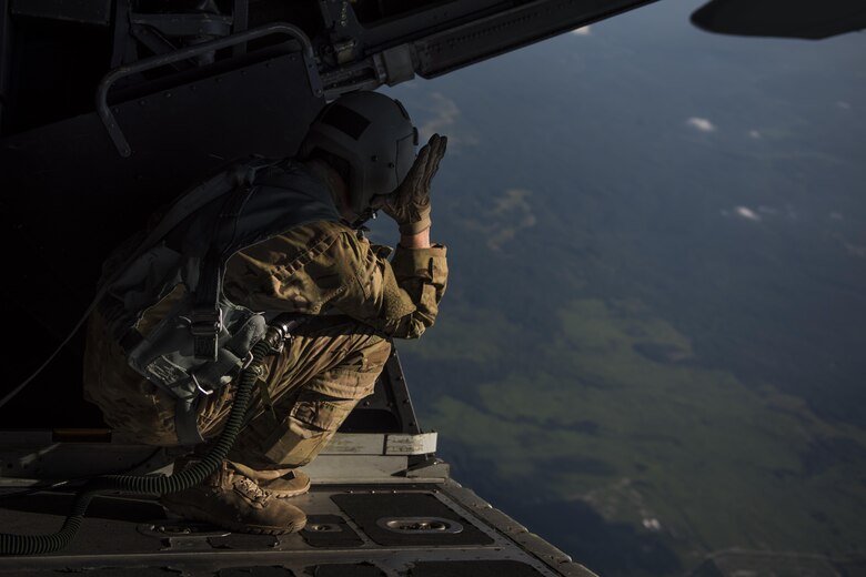 Tech. Sgt. James Kosnosky Jr., a loadmaster with the 15th Special Operation Squadron, counts deployed parachutes as he watches through the ramp door of an MC-130H Combat Talon II after a HALO jump while flying over Terra Haute, Ind., July 8, 2017 in preparation for Total Force Exercise 17-3. The exercise enhances 1st Special Operations Wing Air Commandos' interoperability with other units and services, which is paramount for the joint force mission. (U.S. Air Force photo by Tech. Sgt. Jeffrey Curtin)