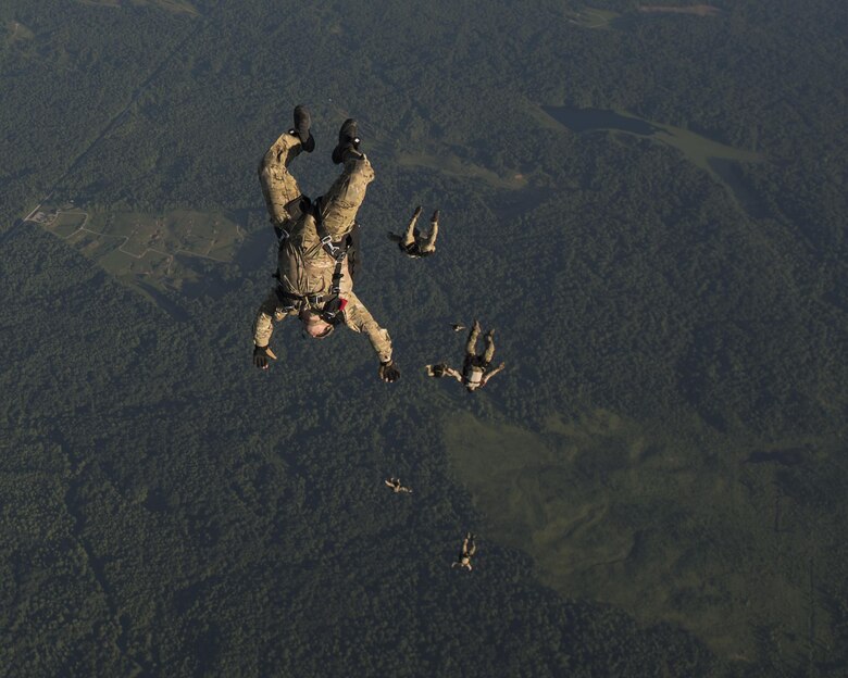 Special Tactics Airmen with the 123rd Special Tactics Squadron, Louisville, KY., execute a high altitude, low open jump out of a 15th Special Operations Squadron MC-130H Combat Talon II, during a total force exercise mission over Terra Haute, Ind., July 8, 2017. If we are taking out the second sentence, we need to add another one...maybe talk about the 123rd mission or the ST mission. (U.S. Air Force photo by Tech. Sgt. Jeffrey Curtin)