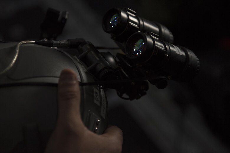 An Air Commando with the 15th Special Operations Squadron secures night vision goggles to his helmet before a night-time aerial refueling mission during Total Force Exercise 17-3 at Sewart Army National Guard base, Smyrna, TN., July 9, 2017.  Units from the 1st Special Operations Wing conduct quarterly exercises with other units and services to increase consistency in tactics and procedures, ensuring their global readiness. (U.S. Air Force photo by Tech. Sgt. Jeffrey Curtin)