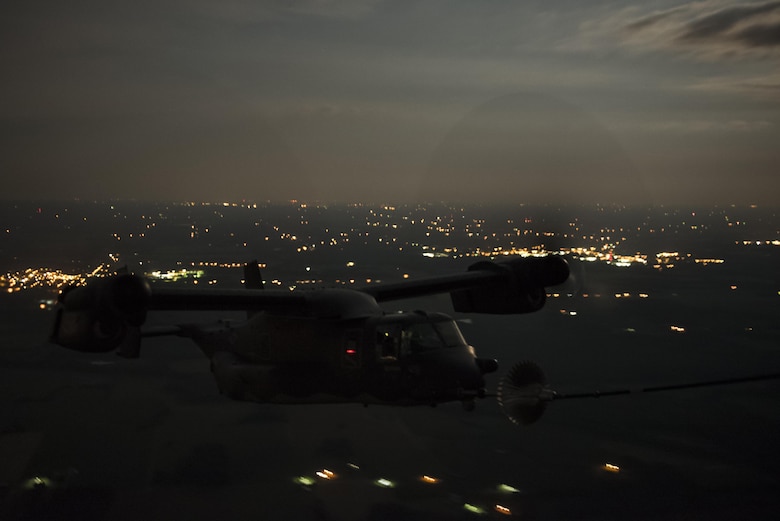 An 8th Special Operations Squadron CV-22 Osprey tiltrotor aircraft receives fuel from a 15th SOS MC-130H Combat Talon II during a total force exercise night-time aerial refueling mission over Louisville, KY., July 9, 2017. Units from the 1st Special Operations Wing conduct quarterly exercises with other units and services to increase consistency in tactics and procedures, ensuring their global readiness. (U.S. Air Force photo by Tech. Sgt. Jeffrey Curtin)