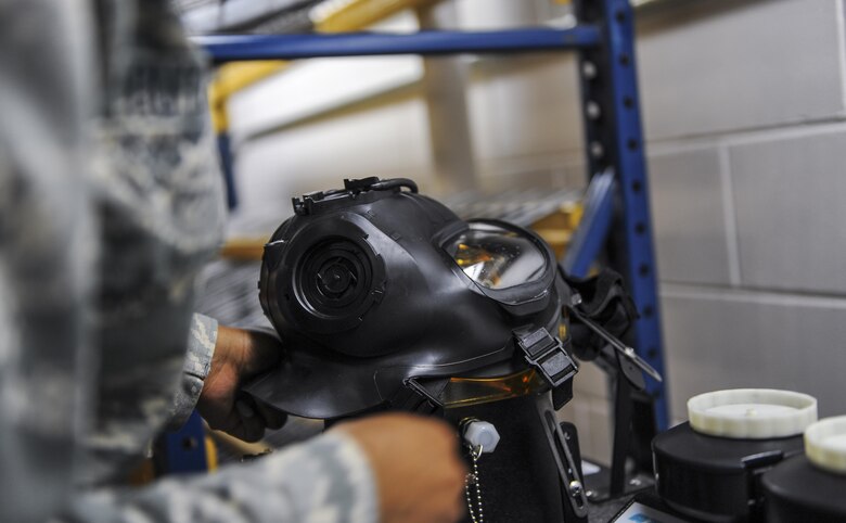 Airman 1st Class Jessica Outlaw, a materiel management journeyman with the 1st Special Operations Logistics Readiness Squadron, uses a Joint Service Mask Leakage Tester to perform a leak test on a gas mask at Hurlburt Field, Fla., July 11, 2017. A JSMLT uses aerosol vapor to check for leaks or blocks on a gas mask. (U.S. Air Force photo by Airman 1st Class Isaac O. Guest IV)