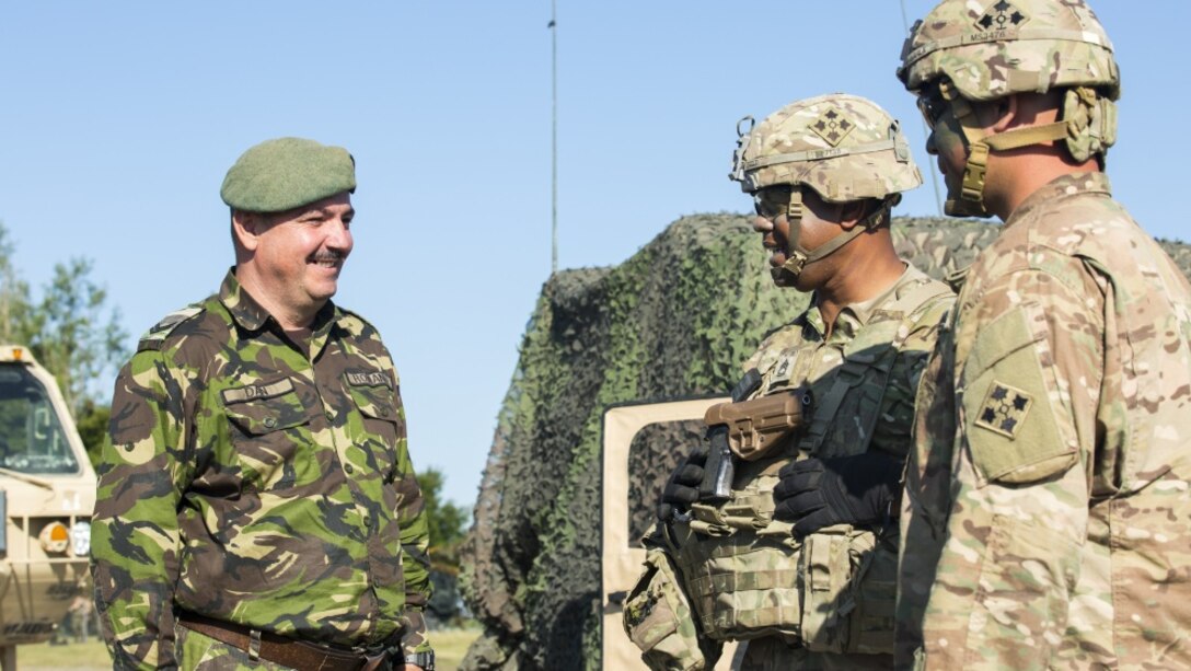 U.S. soldiers with 1st Battalion, 66th Armor Regiment, 3rd Armored Brigade Combat Team, 4th Infantry Division, talk with Romanian soldiers during Exercise Getica Saber 2017 in Cincu, Romania, July 10, 2017. Getica Saber 17 is a U.S.-led fire support coordination exercise and combined arms live-fire exercise that incorporates six Allied and partner nations with more than 4,000 soldiers. Getica Saber 17 runs concurrent with Saber Guardian 17, a U.S. Army Europe-led, multinational exercise that spans across Bulgaria, Hungary and Romania with over 25,000 service members from 22 Allied and partner nations. Army Photo by Spc. Antonio Lewis