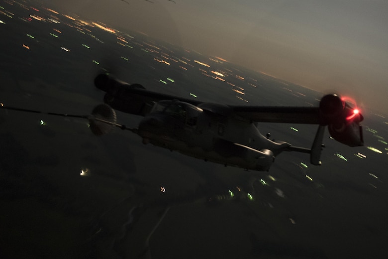 An 8th Special Operations Squadron CV-22 Osprey tiltrotor aircraft receives fuel from a 15th SOS MC-130H Combat Talon II during a total force exercise night-time aerial refueling mission over Louisville, KY., July 9, 2017. Units from the 1st Special Operations Wing conduct quarterly exercises with other units and services to increase consistency in tactics and procedures, ensuring their global readiness. (U.S. Air Force photo by Tech. Sgt. Jeffrey Curtin)