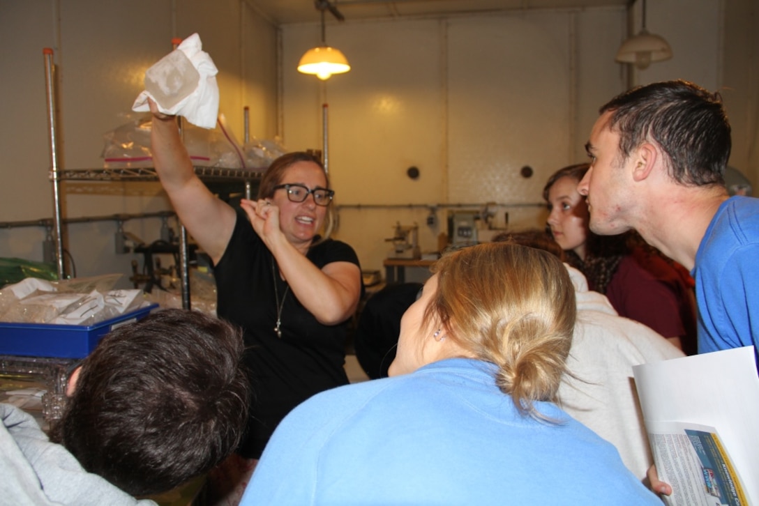 Research mechanical engineer Dr. Zoe Courville displays a chunk of 60,000 year old ice to Advanced Studies Program students from St. Paul’s School in Concord, New Hampshire, during a field trip to the U.S. Army Cold Regions Research Laboratory on July 12.