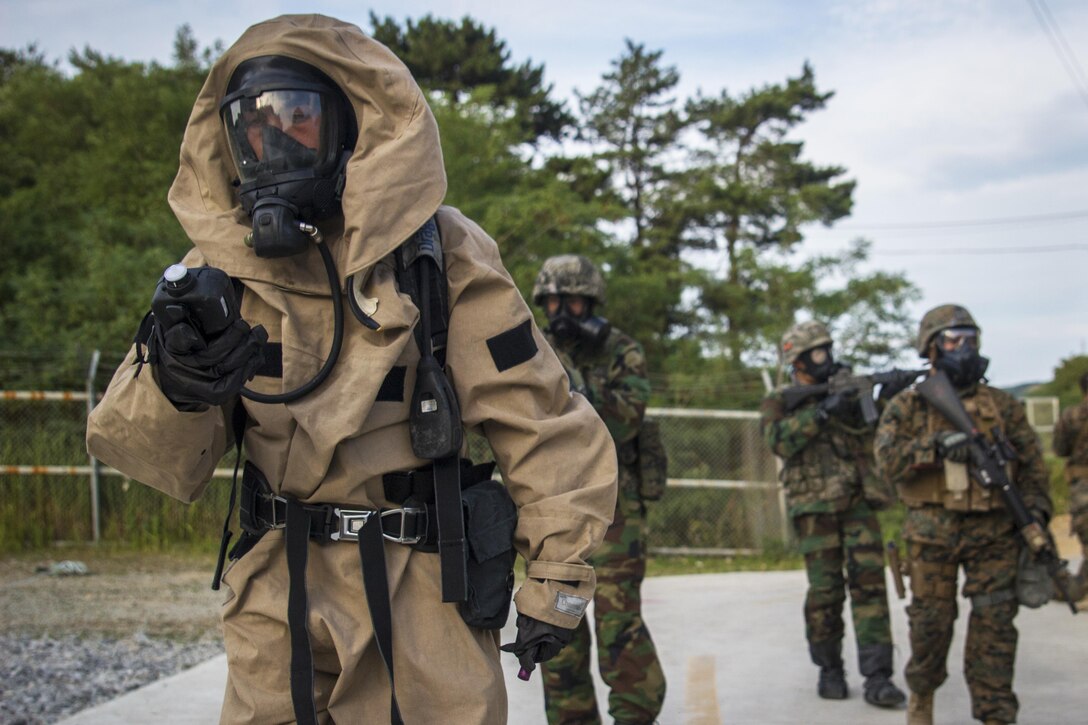 U.S. Marine Corps Lance Cpl. Andres Gomez, a chemical, biological, radiological and nuclear defense specialist, leads a group of U.S. and South Korean Marines into a CBRN response scenario during Exercise Program 17-7 in Pohang, South Korea, July 3, 2017. Marine Corps photo by Lance Cpl. Andy Martinez