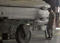 Airman 1st Class Dexter Perpose, 705th Munitions Squadron maintenance team member, walks beside a rotary launcher at Minot Air Force Base, N.D., June 30, 2017. The common strategic rotary launcher houses cruise missiles on the B-52H Stratofortress. (U.S. Air Force photo by Airman 1st Class Jessica Weissman)
