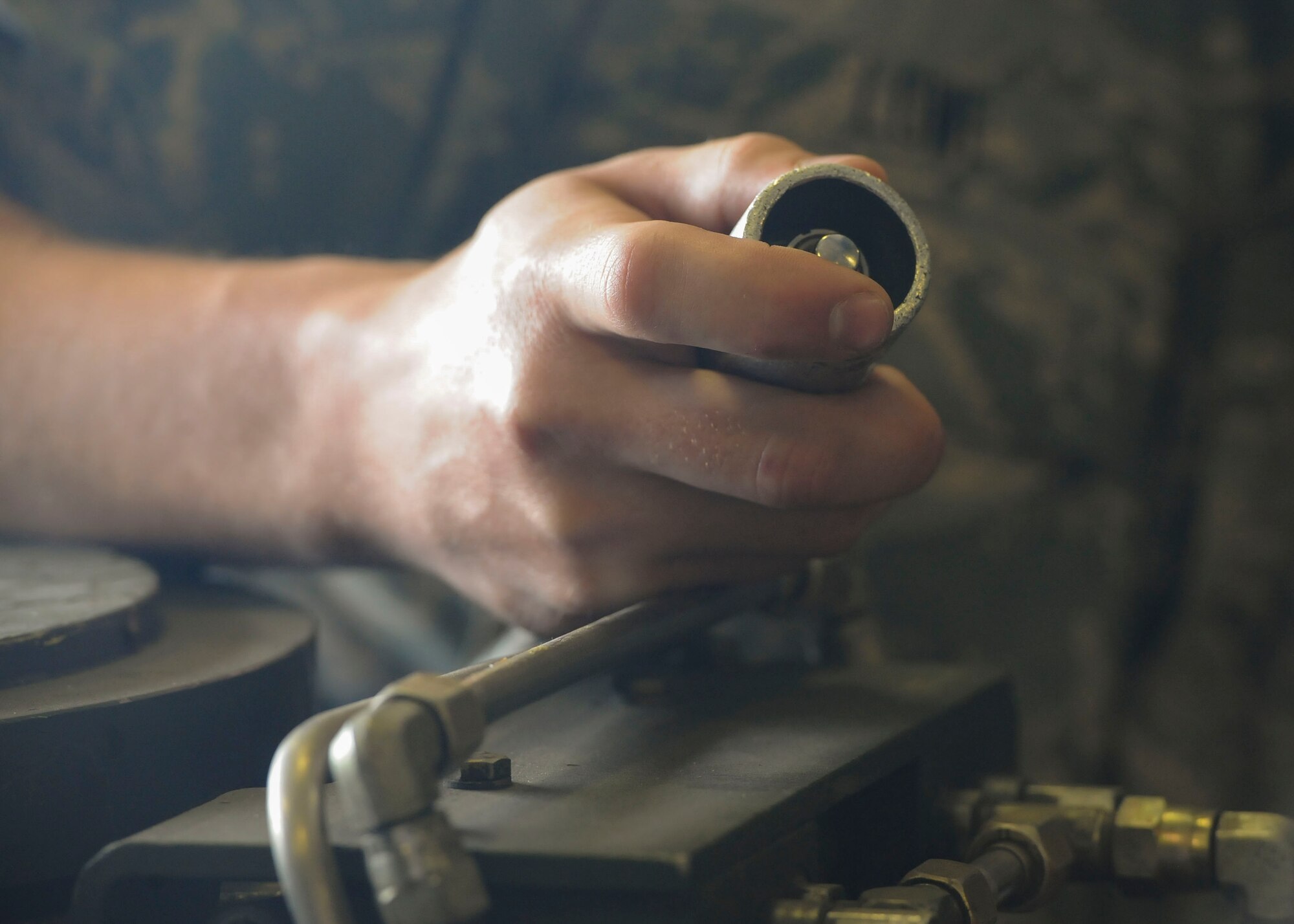 A 705th Munitions Squadron Airman holds a stop switch at Minot Air Force Base, N.D., June 30, 2017. The stop switch is a safety feature that ensures assets are not damaged during trailer operations. (U.S. Air Force photo by Airman 1st Class Jessica Weissman)