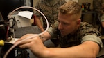 A Marine calibrates a three-dimensional printer during the 3-D Printing Training Course at Marine Corps Base Camp Lejeune, North Carolina. Marines have been embracing 3-D printing for several years now, and there are more than 40 units using 3-D printers in the field to build drones, buildings, vehicles and other items out of various materials. (U.S. Marine Corps photo by Sgt. Ian Leones) 