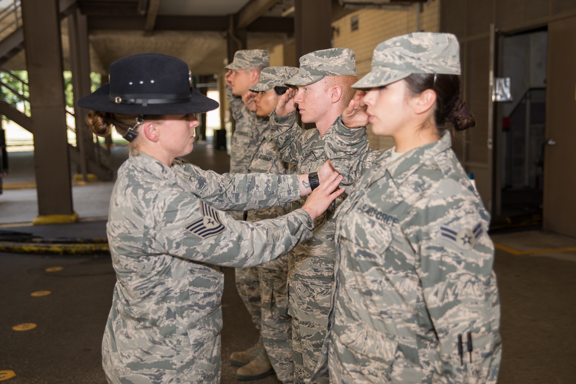 Tech. Sgt. Megan Harper, A 326th Training Squadron military training instructor facilitator, instructs new Airmen on performing a proper salute at the 326th TRS at Joint Base San Antonio-Lackland, Texas June 28, 2017. As a facilitator, Harper’s job is to facilitate classes during Airmen’s Week, a transitionary character development period between basic military training and technical school when Airmen have the opportunity to apply and internalize the Air Force creed and core values taught during BMT. 