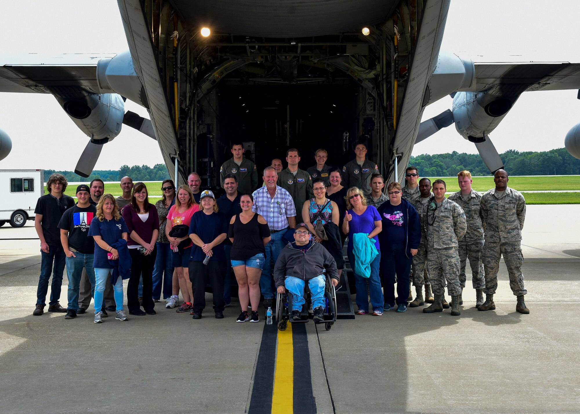 Department of Defense employees pose for a photo behind a C-130H Hercules aircraft after an incentive flight, July 12, 2017, here. Youngstown Air Reserve Station organized the flight for all of the hard work and dedication civilian employees provide to the air base.  (U.S. Air Force Photo/Senior Airman Jeffrey Grossi)
