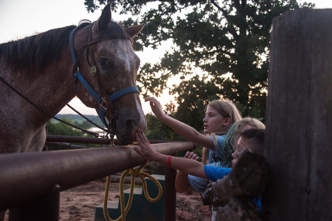Children bond with horses at Camp Victory during the 21st annual Oklahoma National Guard Kids Kamp in Mannford, Okla., July 6, 2017. Oklahoma Air National Guard photo by Air Force Tech. Sgt. Trisha K. Shields