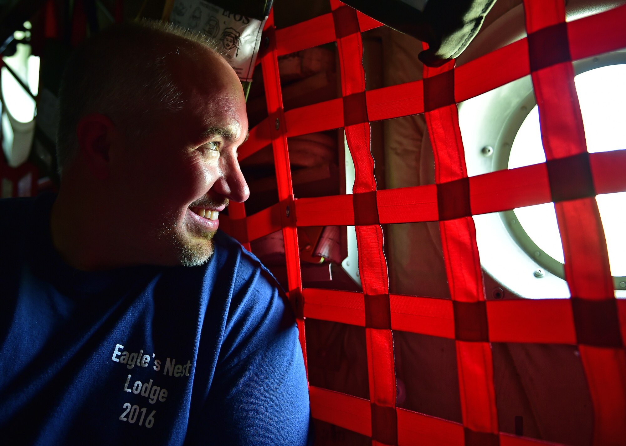 Jason Cohol, a lodging supply technician with the Force Support Squadron here, peers out a C-130H Hercules cargo bay window during an incentive flight, July 12, 2017. Cohol has worked at YARS for 12 years. (U.S. Air Force Photo/Senior Airman Jeffrey Grossi)