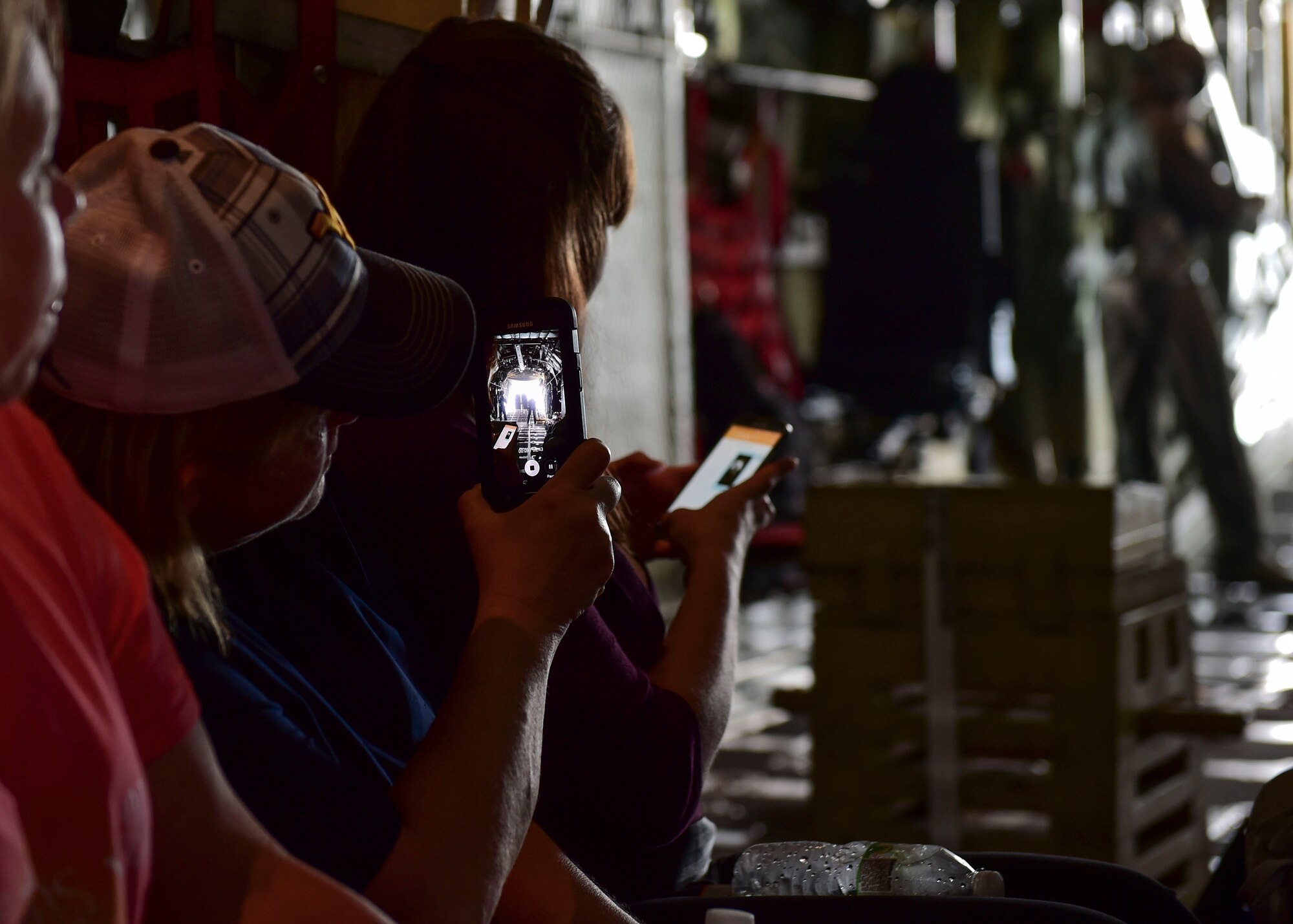 Cori Champ, a cook leader with the Force Support Squadron here, captures a moment on her smart phone during an incentive flight aboard a C-130H Hercules, July 12, 2017. Champ has worked at YARS for almost a decade and had never before flown on a C-130H. (U.S. Air Force Photo/Senior Airman Jeffrey Grossi)