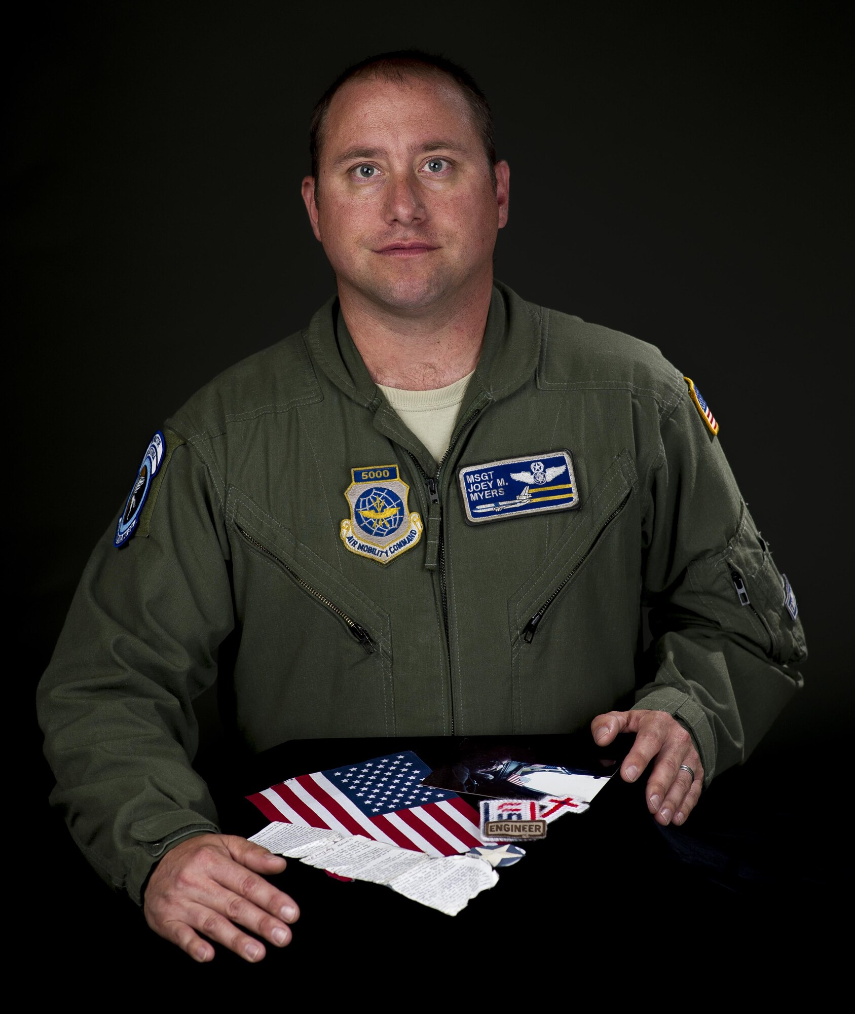 Master Sgt. Joey Myers, 6th Air Refueling Squadron KC-10 Extender flight engineer, displays the items he carries with him around the globe. Men and women serving their country in all branches of the military have traditionally kept meaningful mementos or talismans close to them for good luck, as reminders, to bring comfort or other deeply felt personal reasons. (U.S. Air Force photo/Heide Couch)