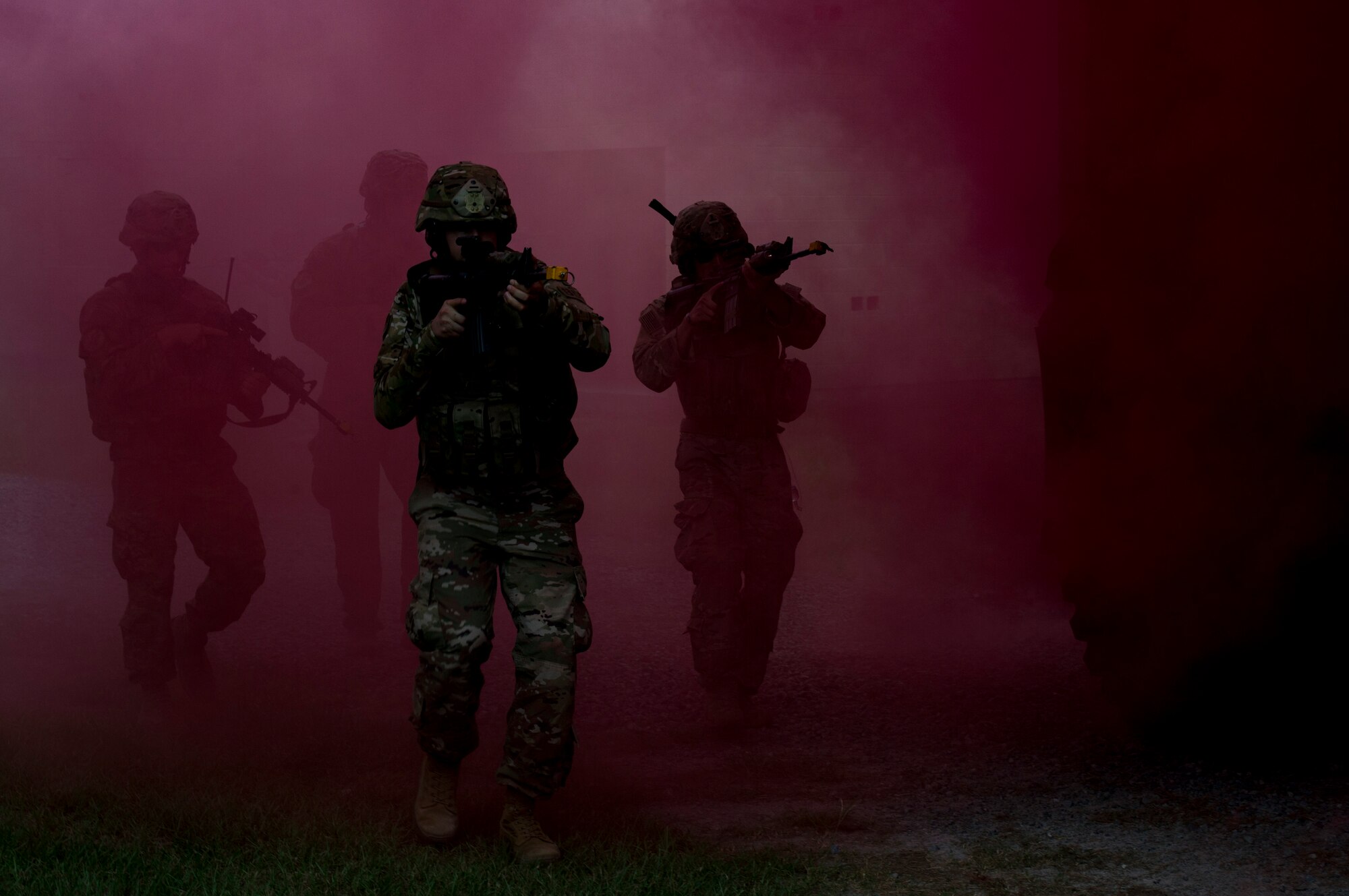 Airmen from the 823d Base Defense Squadron traverse through smoke used for cover during a combat simulation, July 11, 2017, at Moody Air Force Base, Ga. The simulation was part of a tour to show Chief Master Sgt. David Wade, 9th Air Force command chief the capabilities of the squadron. (U.S. Air Force photo by Staff Sgt. Eric Summers Jr.)