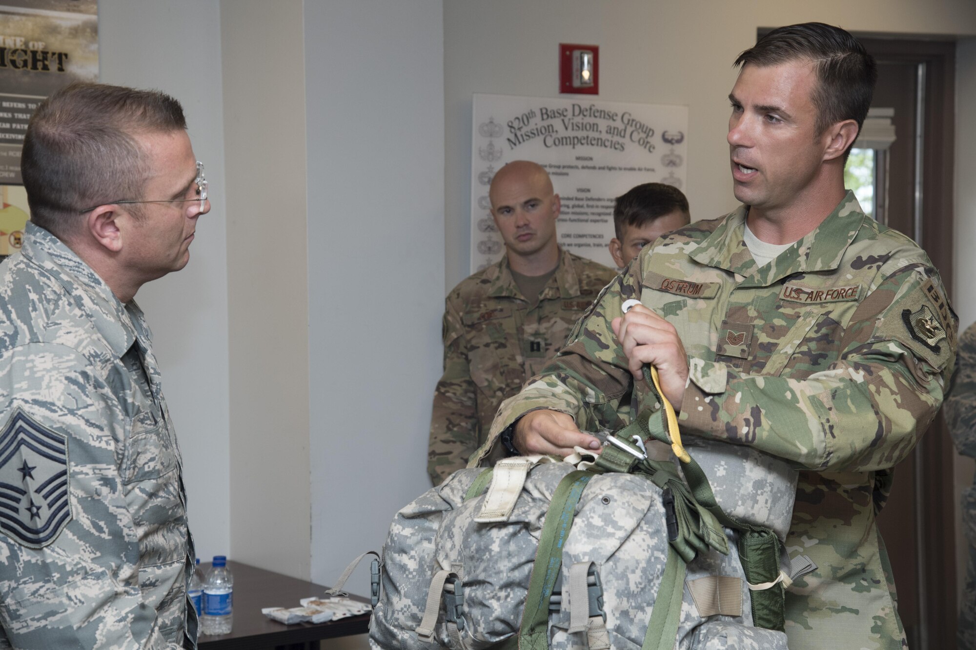Tech. Sgt. Joseph Ostrum, 823d Base Defense Squadron jumpmaster, explains the functionality and differences between two parachute designs to Chief Master Sgt. David Wade, 9th Air Force command chief, during his visit, July 11, 2017, at Moody Air Force Base, Ga. Wade visited the 93d Air Ground Operations Wing and its units at Moody to learn about the units’ missions and capabilities. (U.S. Air Force photo by Staff Sgt. Eric Summers Jr.)