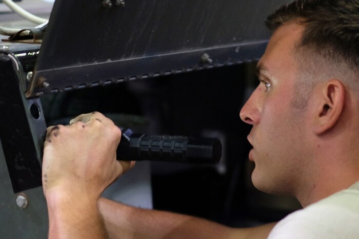 A senior airman with the 380th Expeditionary Maintenance Squadron, working as an aerospace ground equipment journeyman, inspects a floodlight July 12, 2017, at an undisclosed location in southwest Asia. Air Force photo by Senior Airman Preston Webb