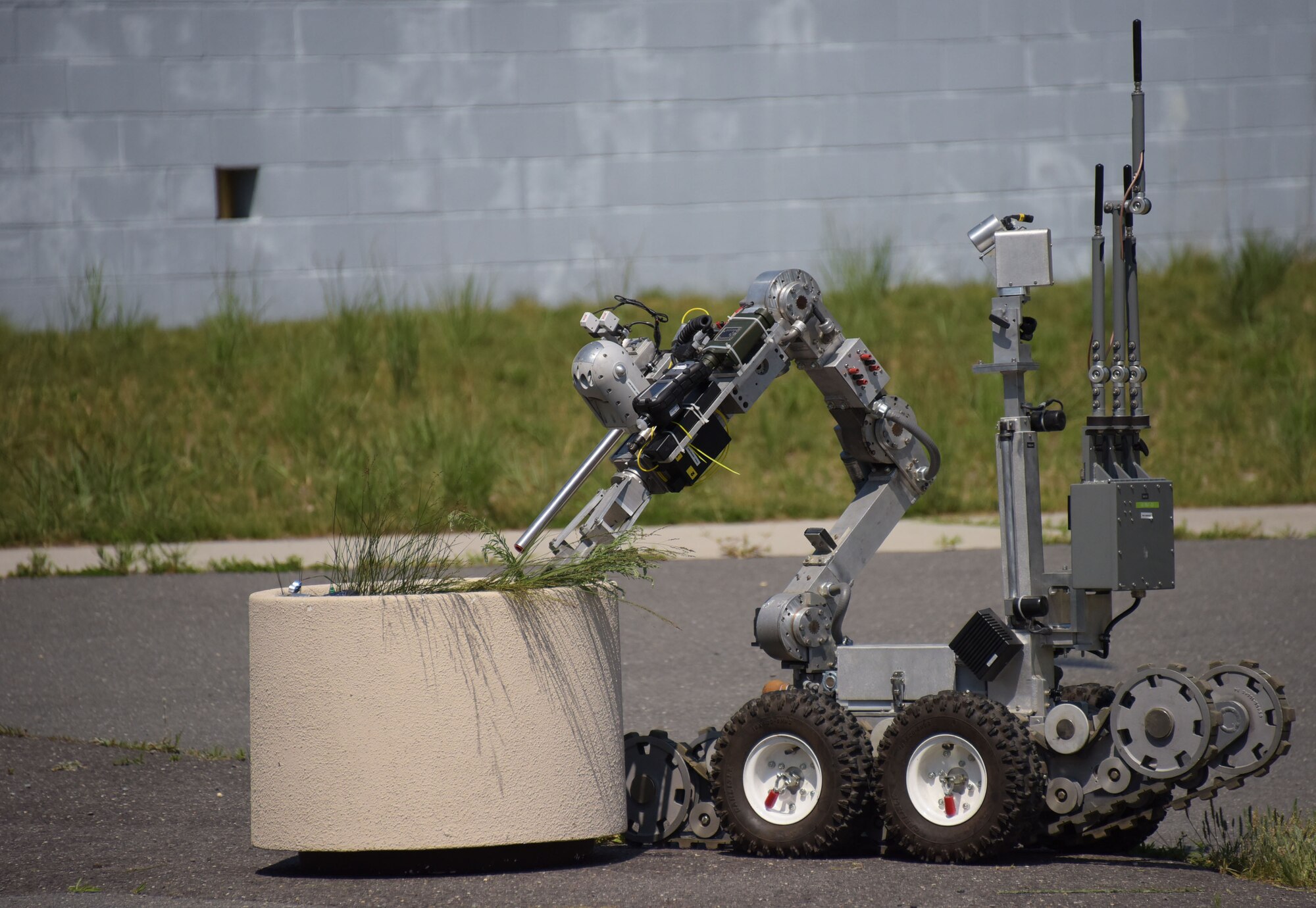 An explosive ordnance disposal robot carefully removes debris from a planter in search of a simulated dispersal unit during a three-day, multi-agency emergency response exercise at Joint Base McGuire-Dix-Lakehurst, New Jersey, on July 12, 2017. EOD technicians with the 87th Civil Engineer Squadron participated in the exercise, along with members of the FBI and Environmental Protection Agency. 