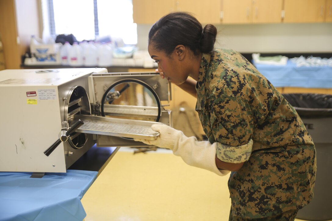 Petty Officer 3rd Class Carlotta Howard, a dental corpsman with 4th Dental Battalion, 4th Marine Logistics Group, Marine Forces Reserve, replaces trays in a sterilization machine during Innovative Readiness Training Louisiana Care 2017 at East St. John High School in Reserve, La., July 12, 2017. The Louisiana Care Innovative Readiness Training event is a joint-service medical mission that provides the military with hands-on readiness training opportunities, while at the same time providing direct and lasting benefits to the residents of Louisiana. (Photo by U.S. Marine Pvt. Samantha Schwoch/Released)