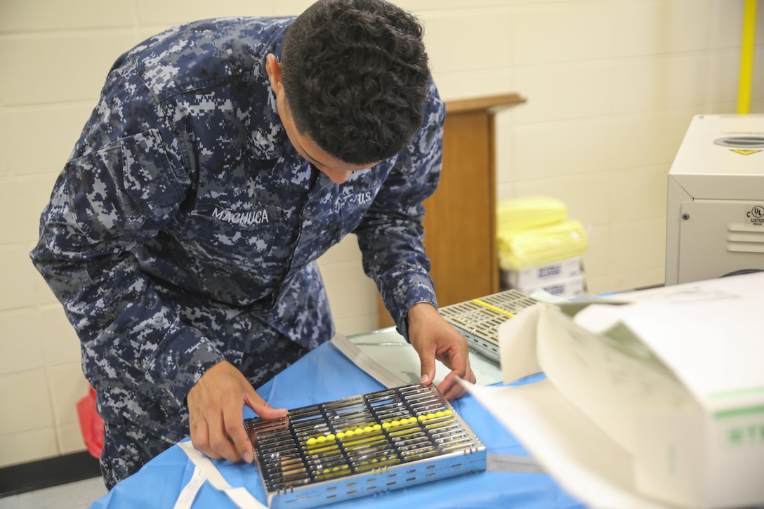 Petty Officer 3rd Class Hasmed Machuca, a dental corpsman with 4th Dental Battalion, 4th Marine Logistics Group, Marine Forces Reserve, prepares dental extraction equipment for sterilization during Innovative Readiness Training Louisiana Care 2017 at East St. John High School in Reserve, La., July 12, 2017. The Louisiana Care IRT event is a joint service medical mission that provides service members the opportunity to increase public awareness and understanding of the Marine Corps and Navy while increasing overall training and readiness. (Photo by U.S. Marine Corps Pvt. Samantha Schwoch/Released)